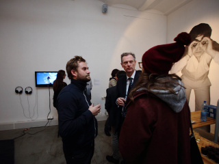 In the background: The video work 'Greenwax On' documenting a performance by Karner/Samaraweerova and a print from the series 'Friendly fire, which we won' by Alexandru Raevschi.